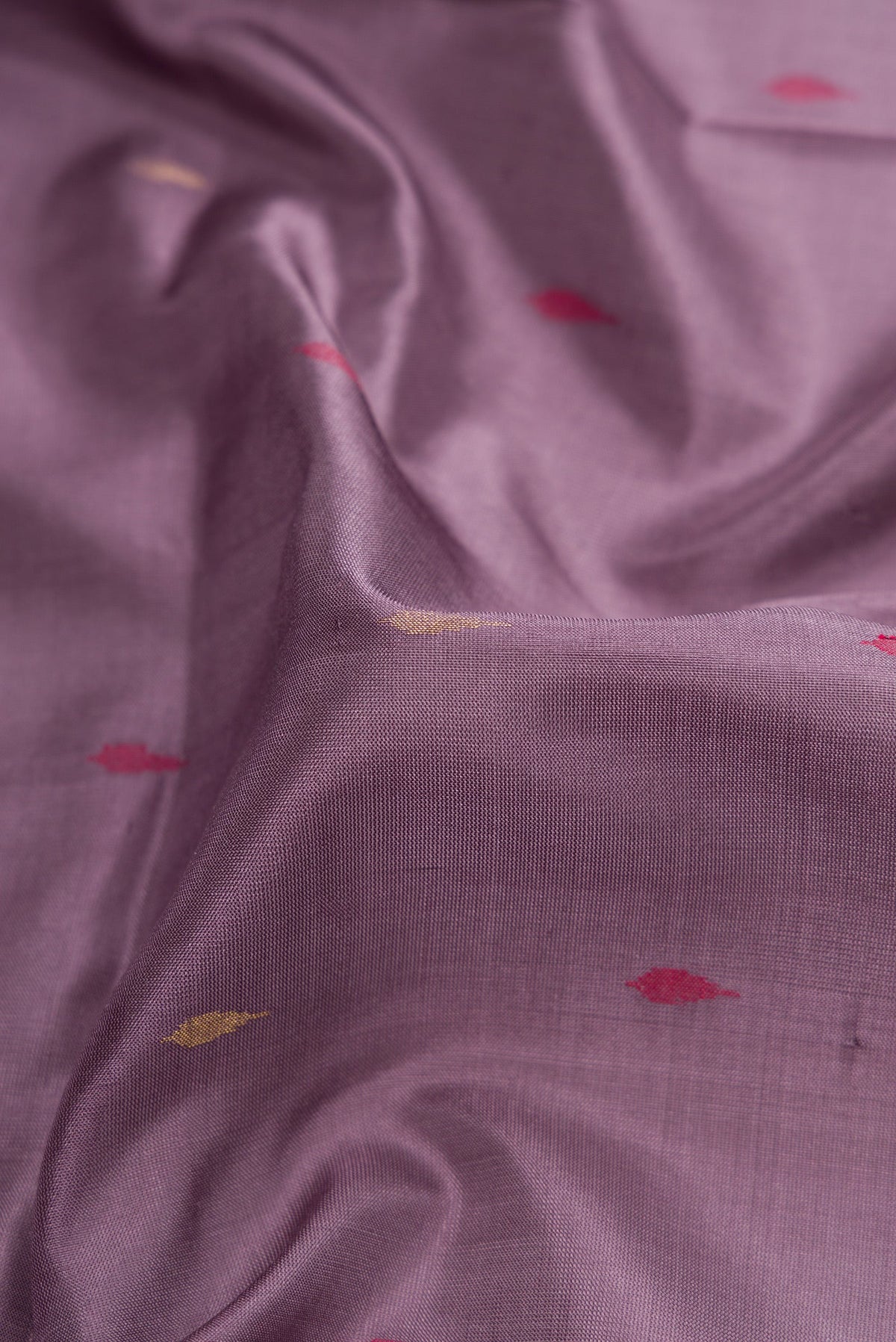 Close up of Purple Dual Tone Uppada Silk Saree with Zari And Thread Butta on the body and Zari Border.  displaying folds