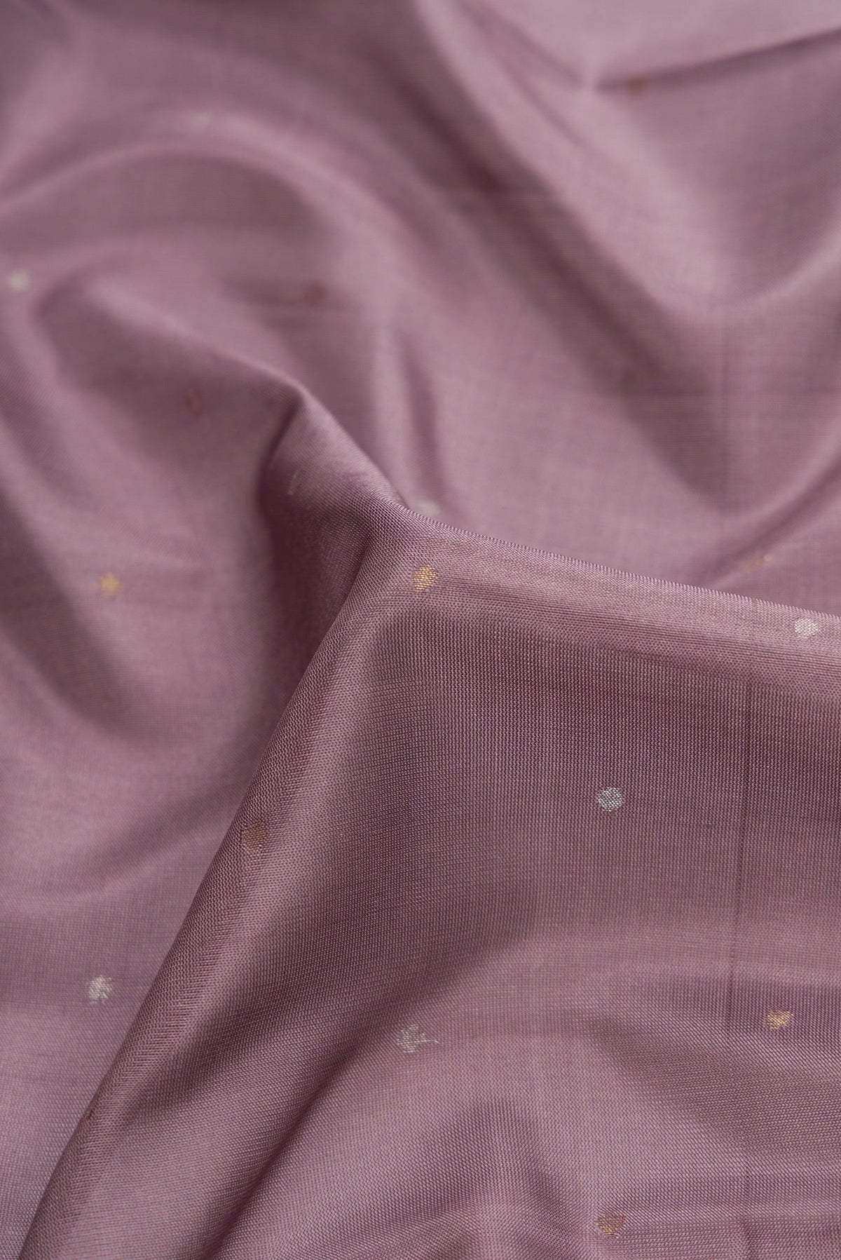 Close up of Lavender Dual Tone Uppada Silk Saree with Zari Butta on the body and Zari Border.  displaying folds