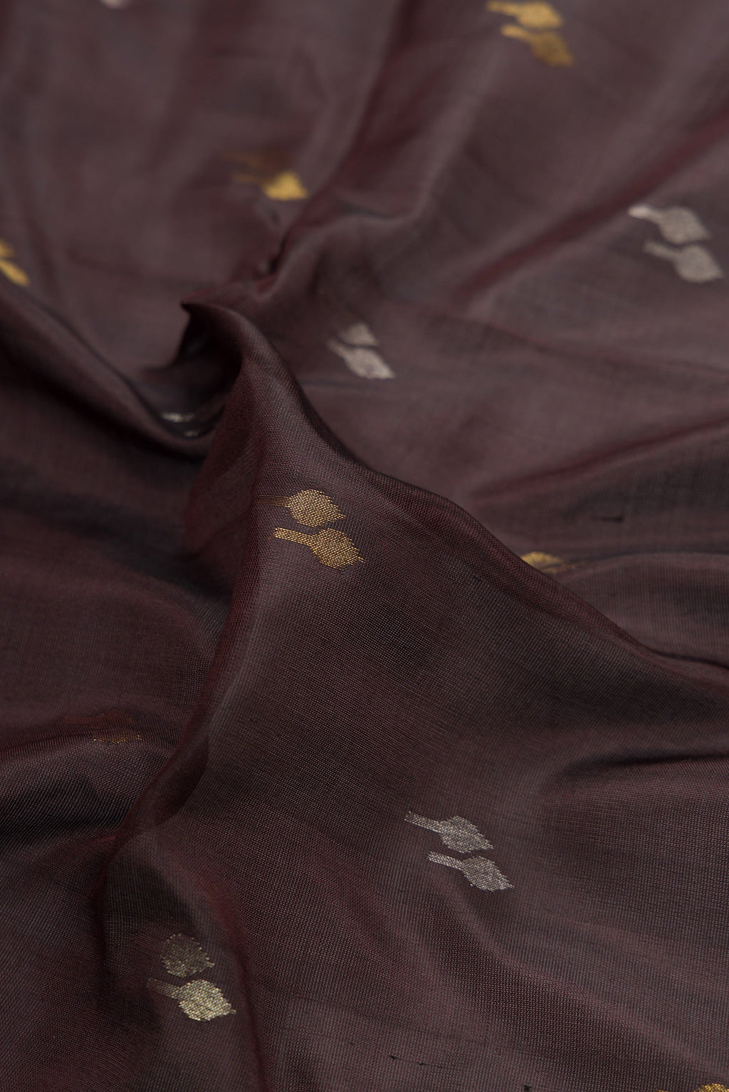 Close up of Coffee Brown Dual Tone Uppada Silk Saree with Zari Butta on the body and Zari Border.  displaying folds