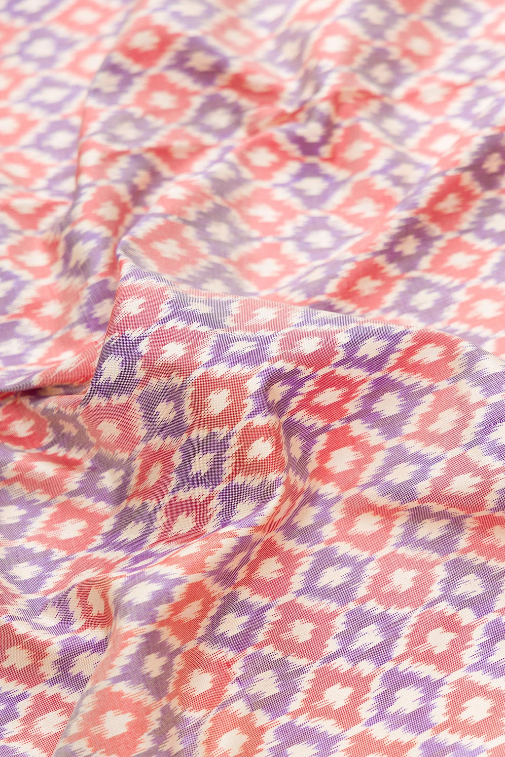 Close up of Lilac Dual Tone Double Ikat Saree with Ikat Print on the body and Zari Border.  displaying folds