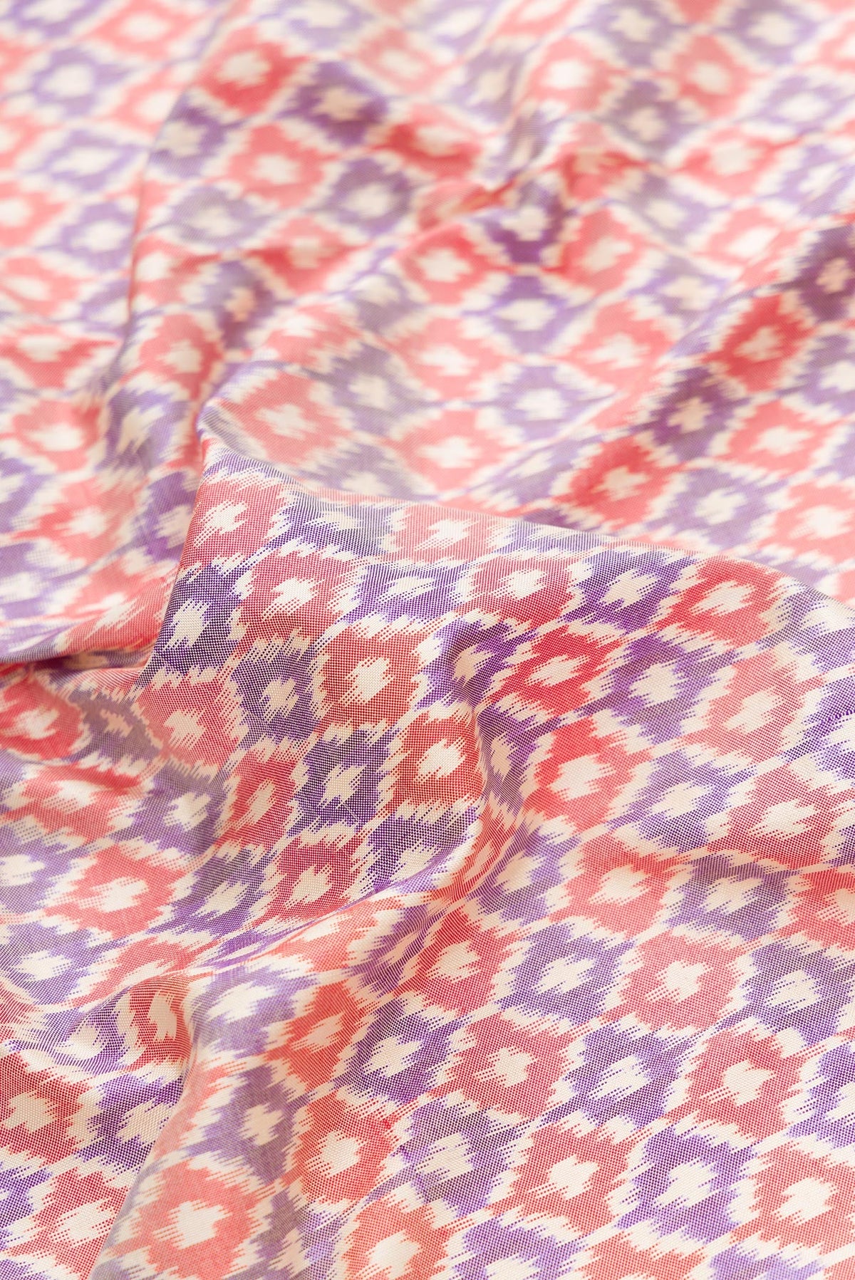 Close up of Lilac Dual Tone Double Ikat Saree with Ikat Print on the body and Zari Border.  displaying folds