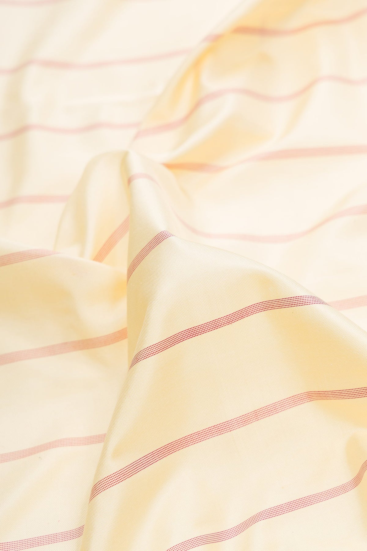 Close up of Sandal Dual Tone Double Ikat Saree with Stripes on the body and Ikat Border.  displaying folds
