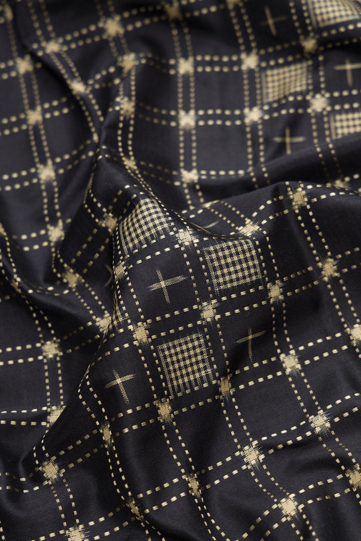 Close up of Black Dual Tone Banarasi Silk Saree with Zari Butta on the body and Zari Border.  displaying folds