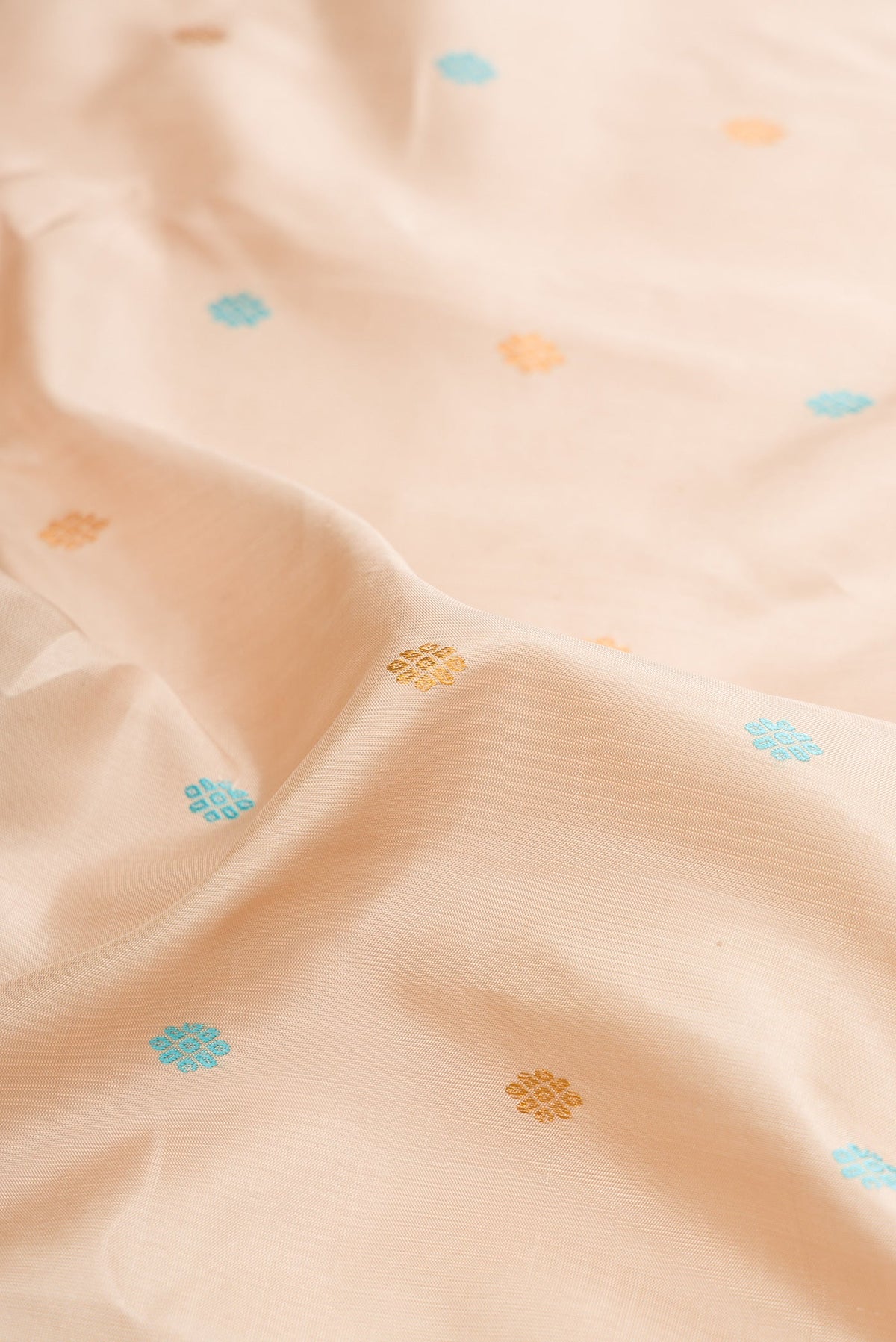 Close up of Dark Beige Dual Tone Gadwal Silk Saree with Zari And Thread Butta on the body and Zari Border.  displaying folds