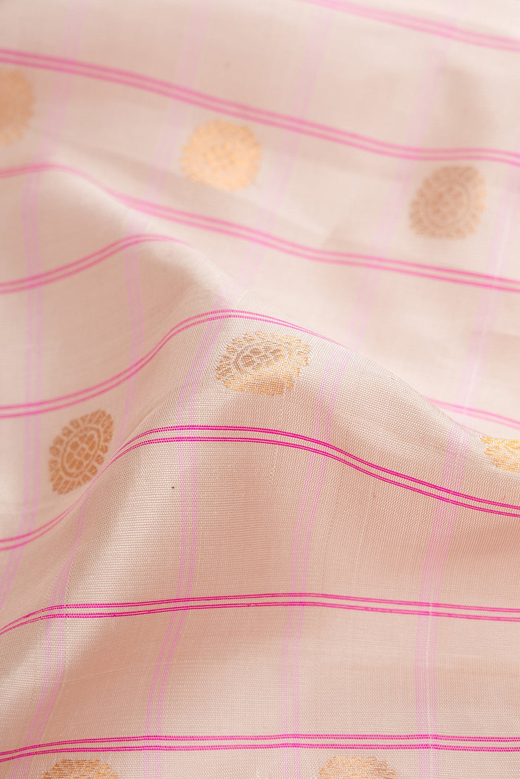 Close up of Beige Dual Tone Gadwal Silk Saree with Checked design on the body and Zari Border.  displaying folds