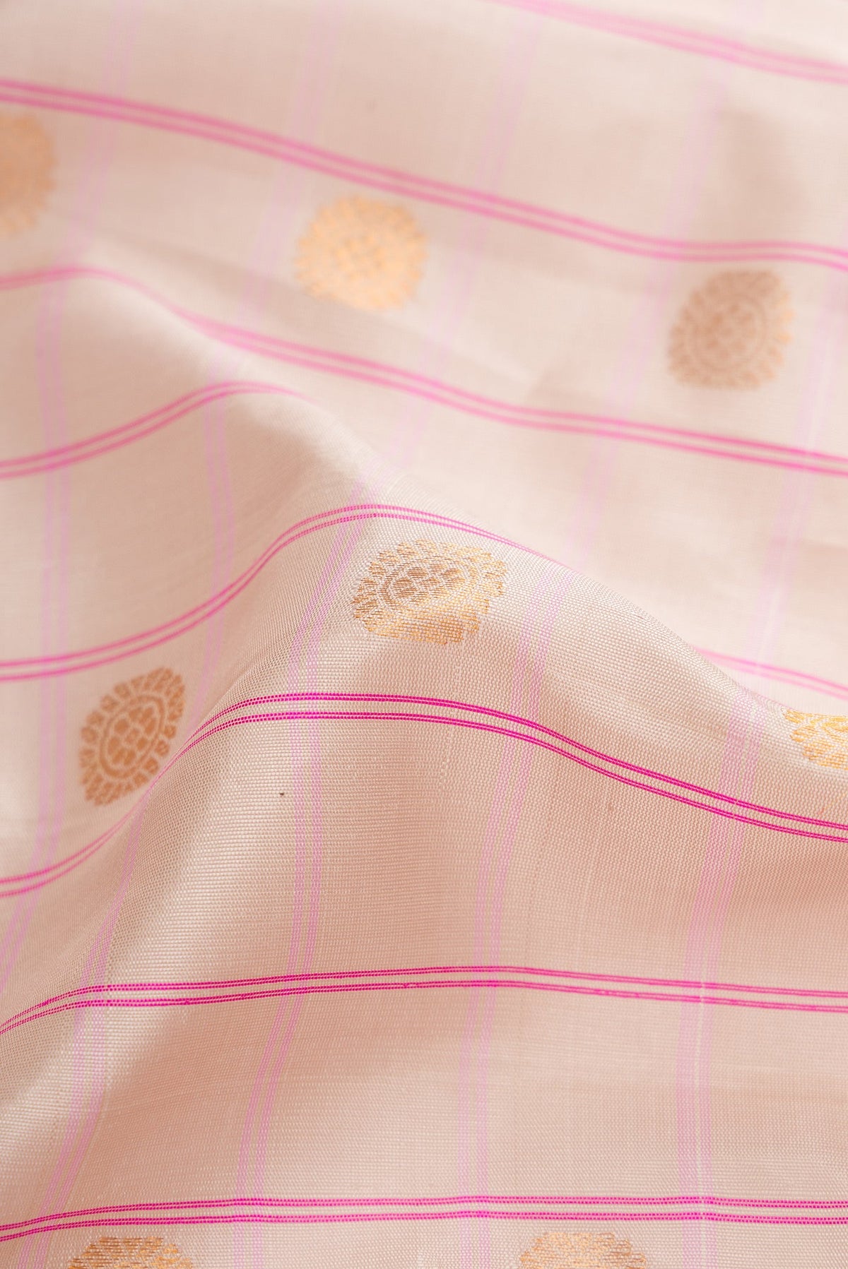 Close up of Beige Dual Tone Gadwal Silk Saree with Checked design on the body and Zari Border.  displaying folds