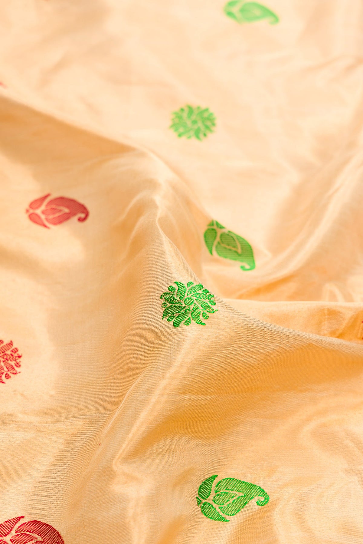 Close up of Gold Dual Tone Gadwal Silk Saree with Zari And Thread Butta on the body and Zari And Thread Border.  displaying folds