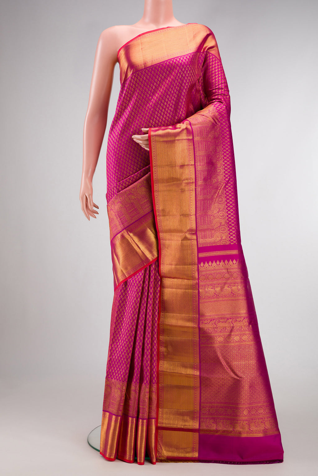 Magenta Kanjivaram Silk Saree with Zari Brocade on the body and Zari Border.  displayed on a mannequin
