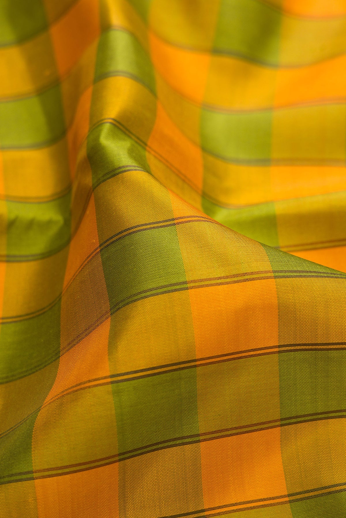 Close up of Pure Silk Pure Zari Green and Yellow Color Kanchipuram Saree with Checked design on the body and Temple Border.  displaying folds