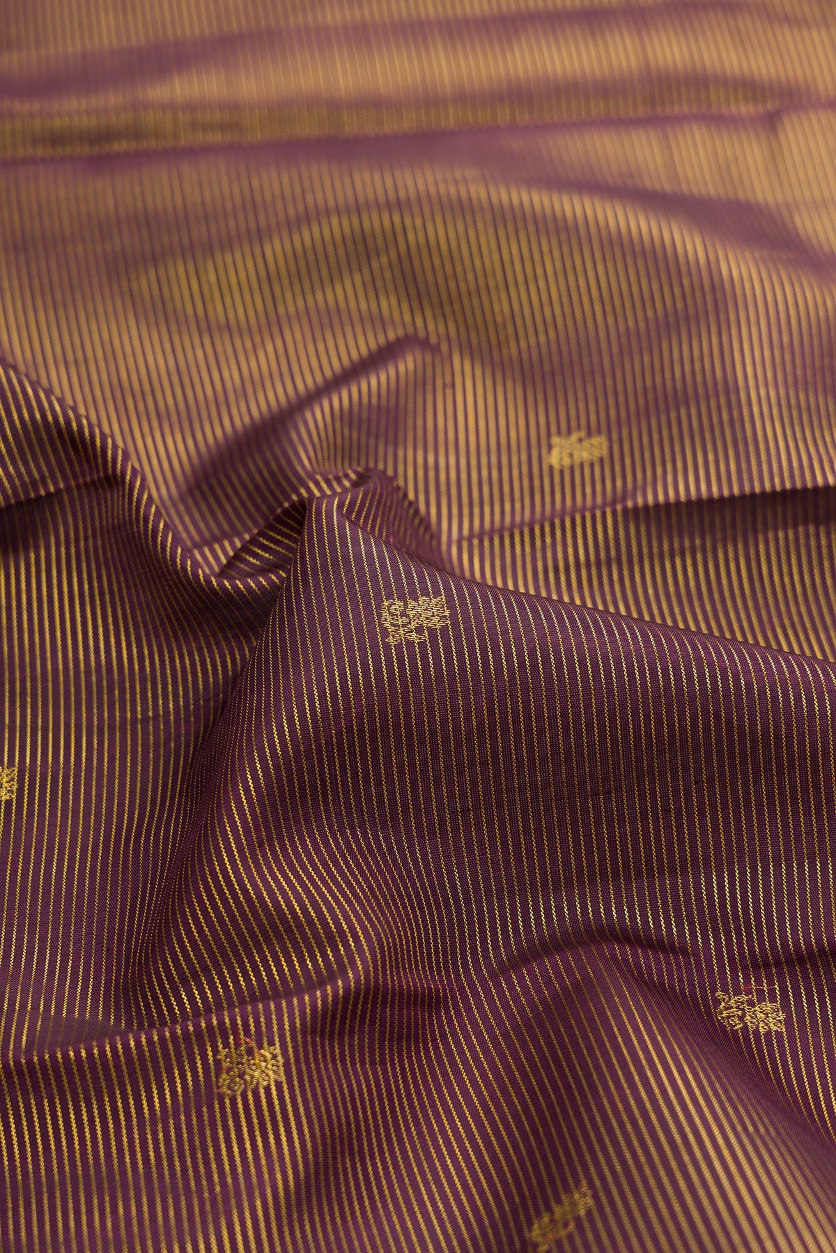 Close up of Coffee Brown Kanchipuram Silk Saree with Zari Butta on the body and Zari Border.  displaying folds
