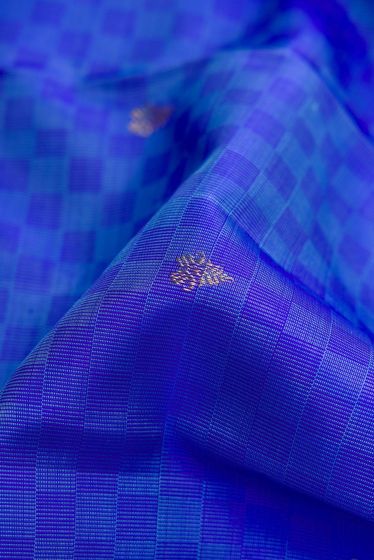 Close up of Pure Silk Pure Zari Light Blue Dual Tone Kanchipuram Saree with Zari Butta on the body and Fancy Border.  displaying folds