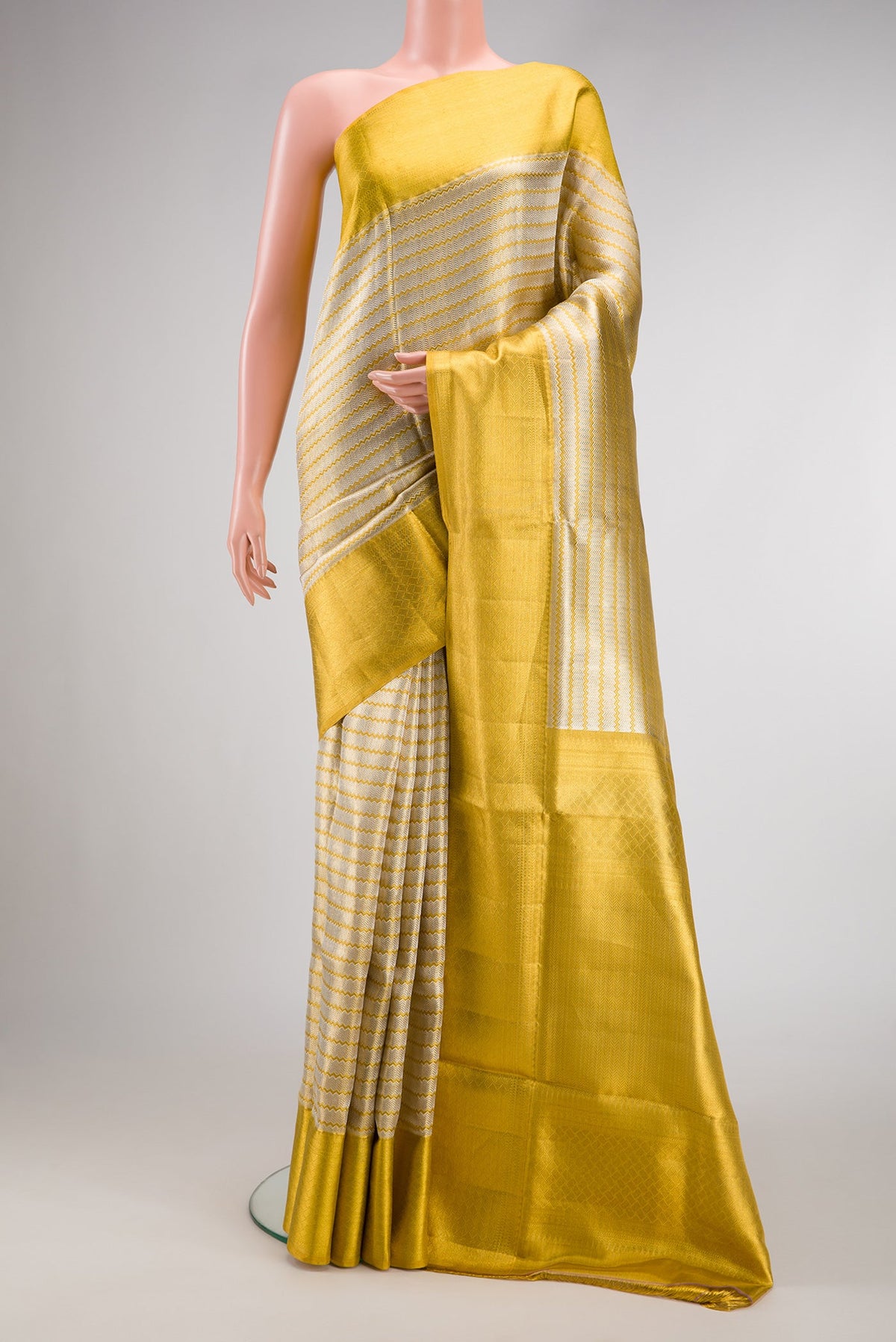 Silver Dual Tone Kanjivaram Tissue Silk Saree with Zari Brocade on the body and Zari Border.  displayed on a mannequin