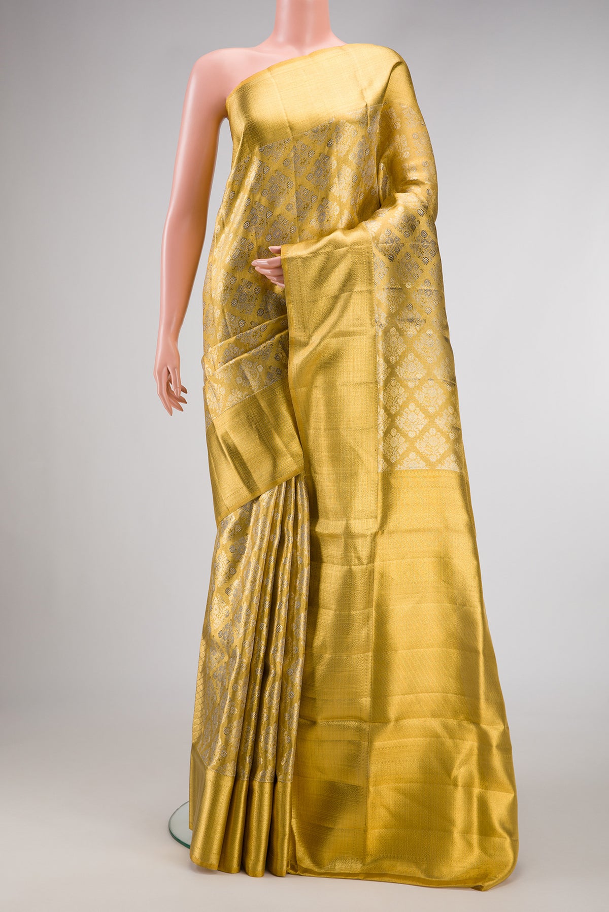 Gold Dual Tone Kanjivaram Tissue Silk Saree with Zari Brocade on the body and Zari Border.  displayed on a mannequin
