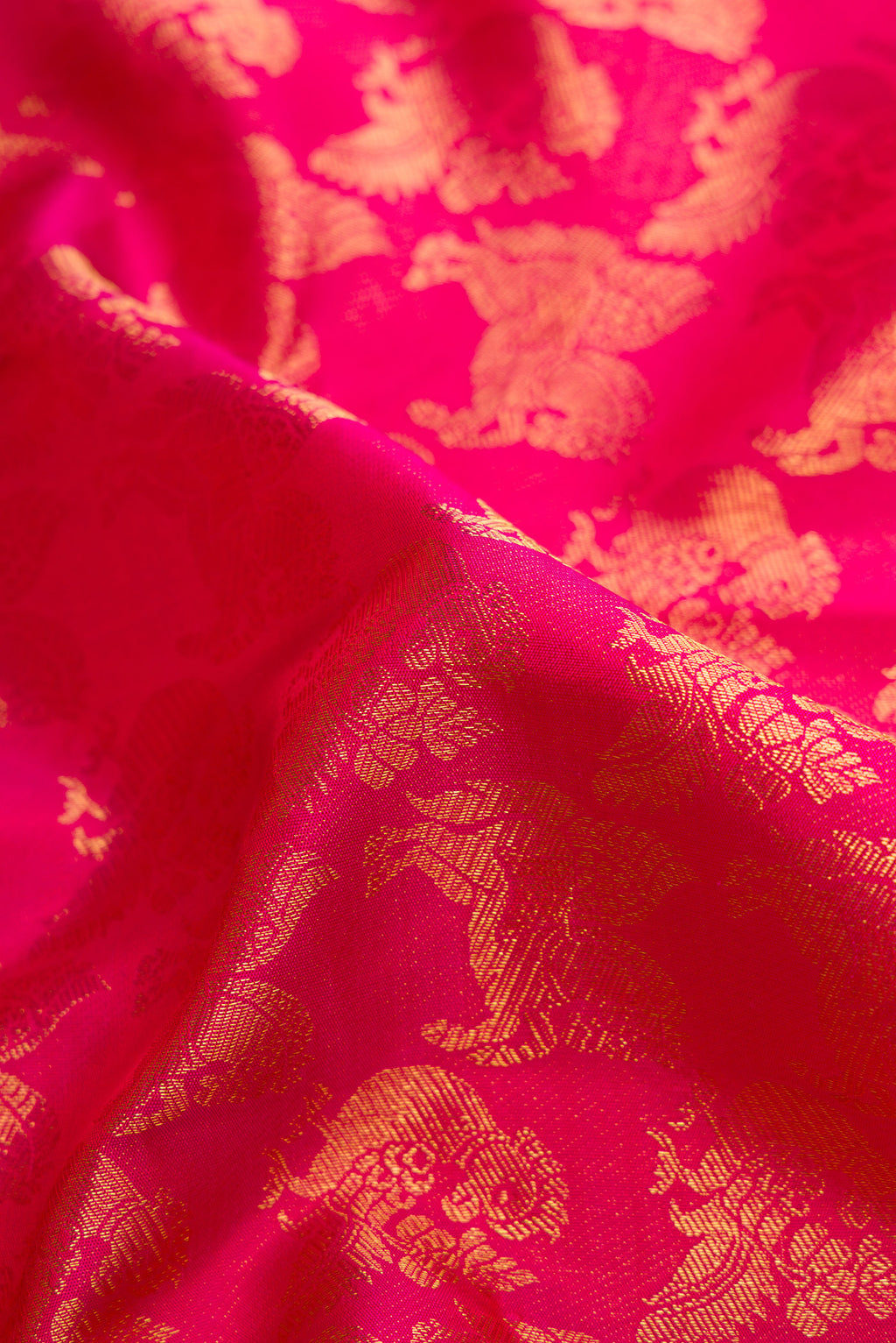 Close up of Pink Kanchipuram Silk Saree with Zari Brocade on the body and Zari Border.  displaying folds