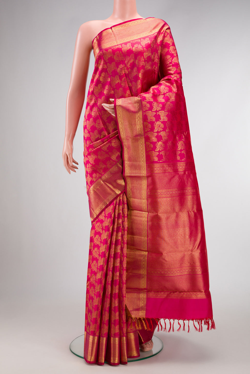 Pink Kanchipuram Silk Saree with Zari Brocade on the body and Zari Border.  displayed on a mannequin