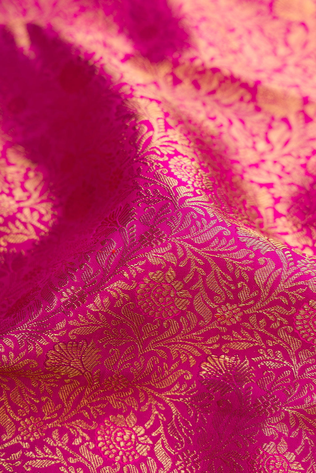 Close up of Pink Dual Tone Kanjivaram Silk Saree with Zari Brocade on the body and Zari Border.  displaying folds