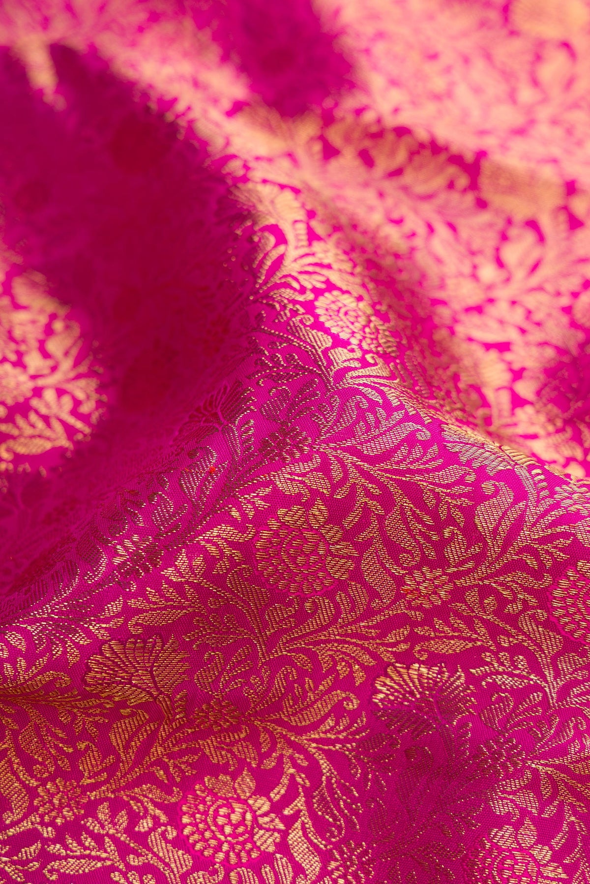 Close up of Pink Dual Tone Kanjivaram Silk Saree with Zari Brocade on the body and Zari Border.  displaying folds