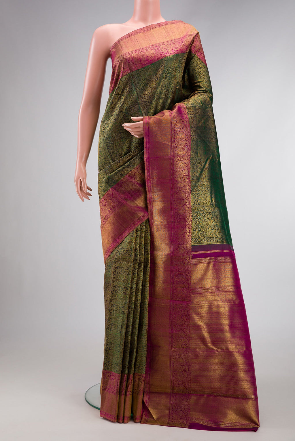 Green Dual Tone Kanchipuram Silk Saree with Zari Brocade on the body and Zari Border.  displayed on a mannequin
