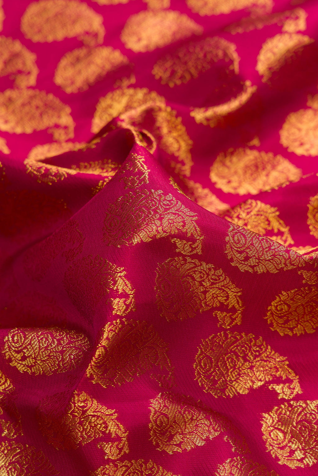 Close up of Maroon Dual Tone Kanjivaram Silk Saree with Zari Brocade on the body and Zari Border.  displaying folds