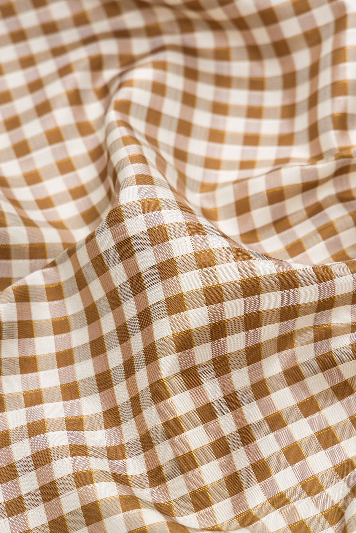 Close up of Pure Silk Pure Zari Beige Dual Tone Kanchipuram Saree with Checked design on the body and Ganga Jamuna Border.  displaying folds