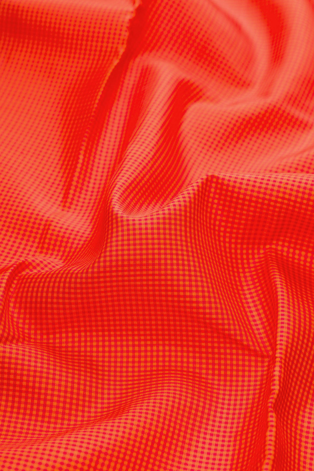 Close up of Pure Silk Pure Zari Orange Kanchipuram Saree with Checked design on the body and Without Border.  displaying folds