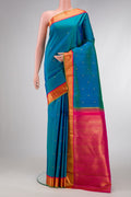 Pure Silk Pure Zari Peacock Blue Dual Tone Kanjivaram Saree with Zari Butta on the body and Zari Border.  displayed on a mannequin