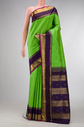 Pure Silk Pure Zari Parrot Green Dual Tone Kanjivaram Saree with Stripes on the body and Zari And Thread Border.  displayed on a mannequin