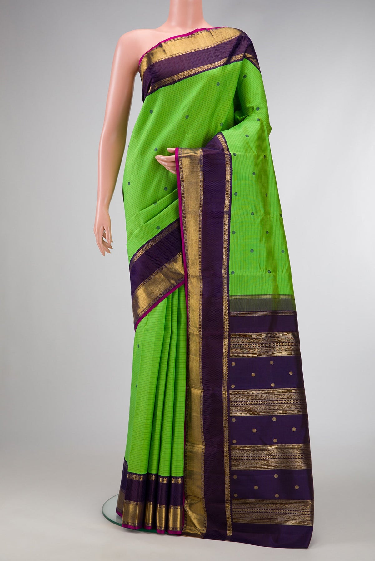 Pure Silk Pure Zari Parrot Green Dual Tone Kanjivaram Saree with Stripes on the body and Zari And Thread Border.  displayed on a mannequin