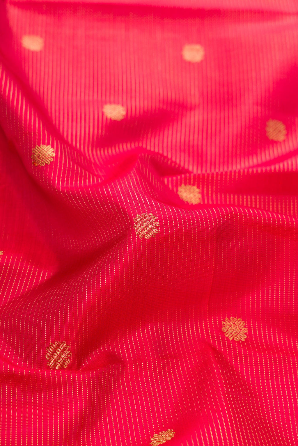 Close up of Pure Silk Pure Zari Red Dual Tone Kanjivaram Saree with Stripes on the body and Zari Border.  displaying folds