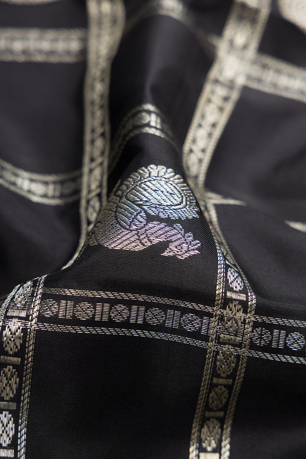 Close up of Beige and Off White Dual Tone Kanchipuram Silk Saree with Checked design on the body and Zari Border.  displaying folds