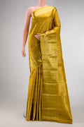 Mustard Kanchipuram Silk Saree with Zari Brocade on the body and Zari Border.  displayed on a mannequin