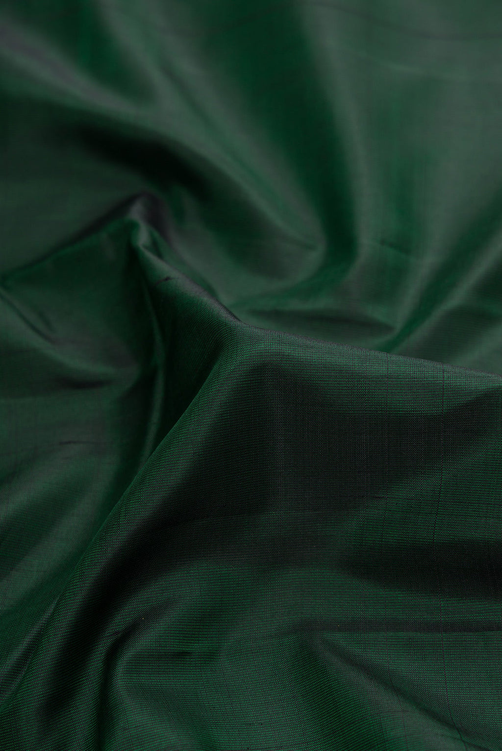 Close up of Bottle Green Dual Tone Kanjivaram Silk Saree with Plain Body and Zari Border.  displaying folds