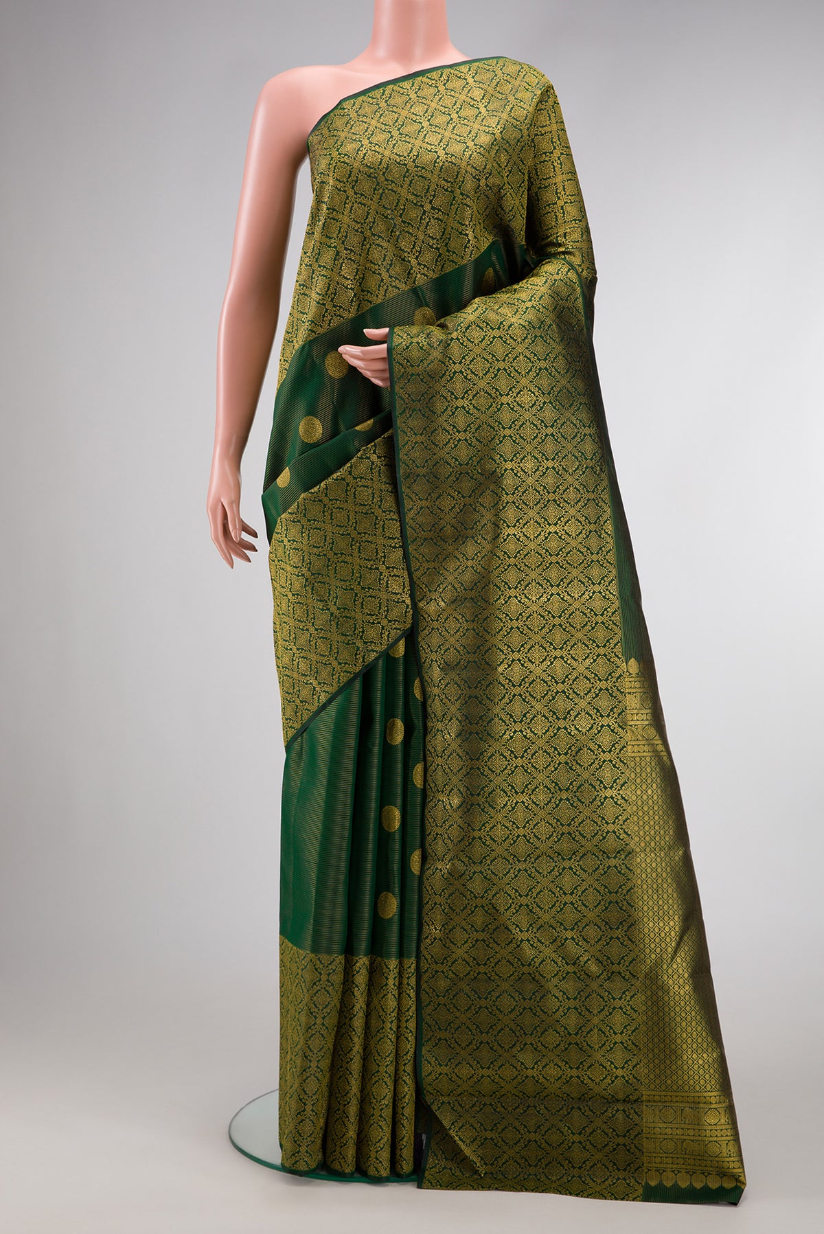 Bottle Green Kanchipuram Silk Saree with Zari Butta on the body and Zari Border.  displayed on a mannequin