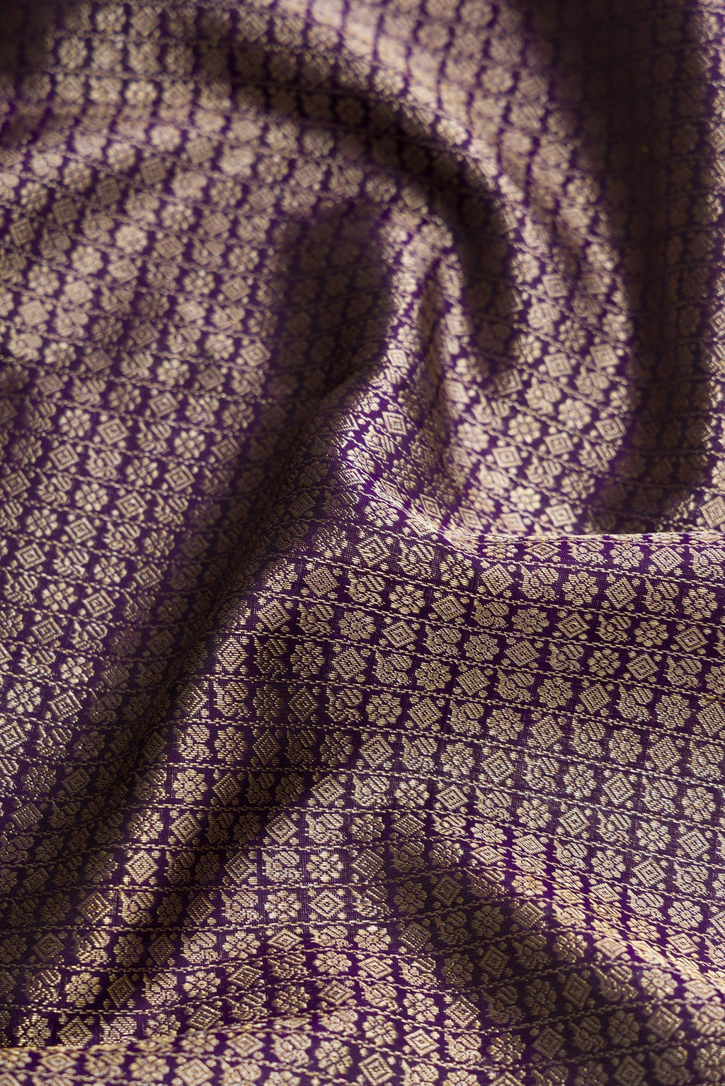 Close up of Violet Dual Tone Kanchipuram Silk Saree with Zari Brocade on the body and Zari Border.  displaying folds