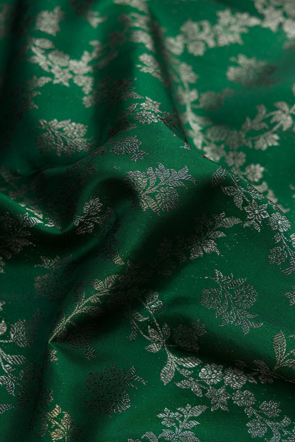 Close up of Bottle Green Dual Tone Kanjivaram Silk Saree with Zari Brocade on the body and Zari Border.  displaying folds