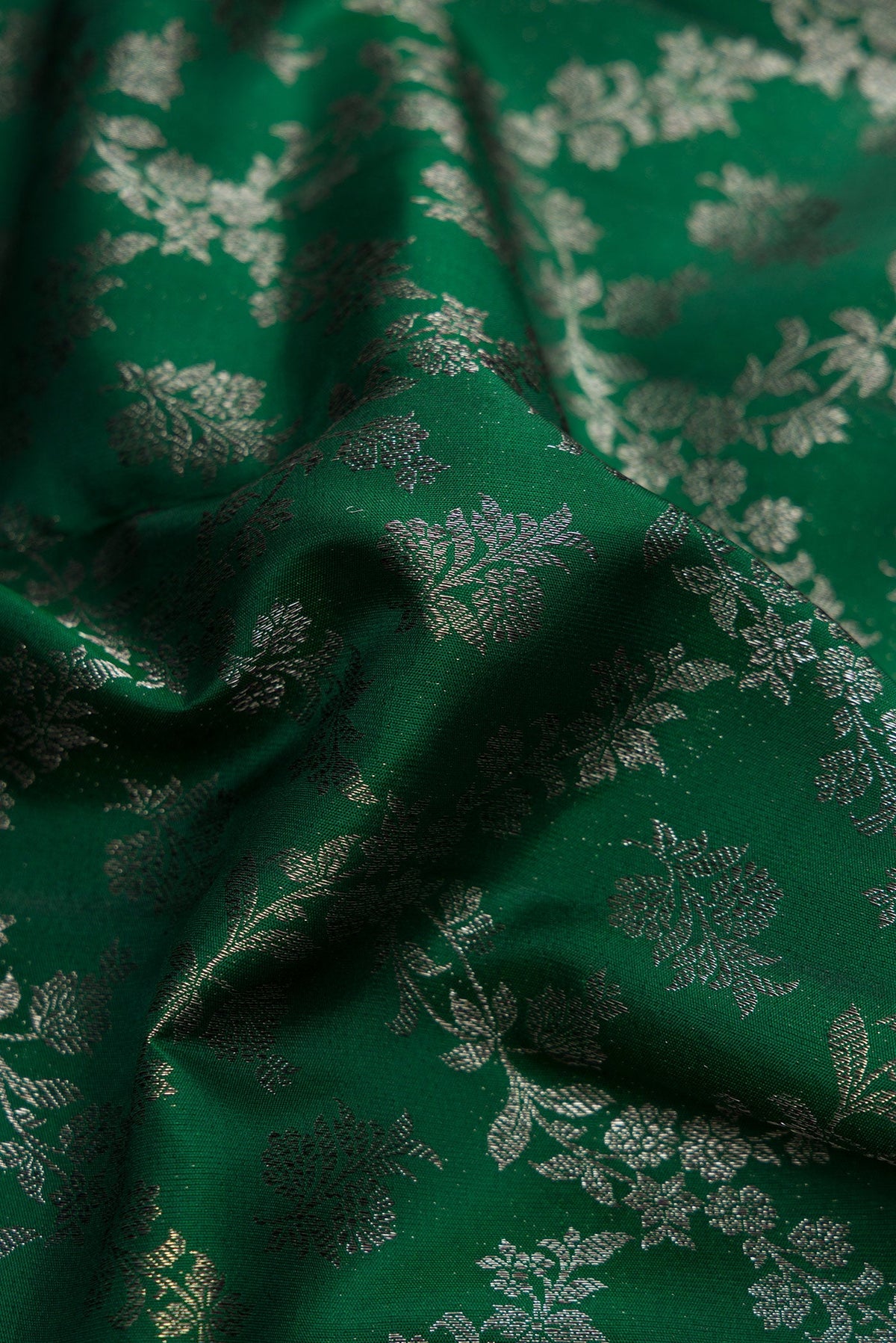 Close up of Bottle Green Dual Tone Kanjivaram Silk Saree with Zari Brocade on the body and Zari Border.  displaying folds