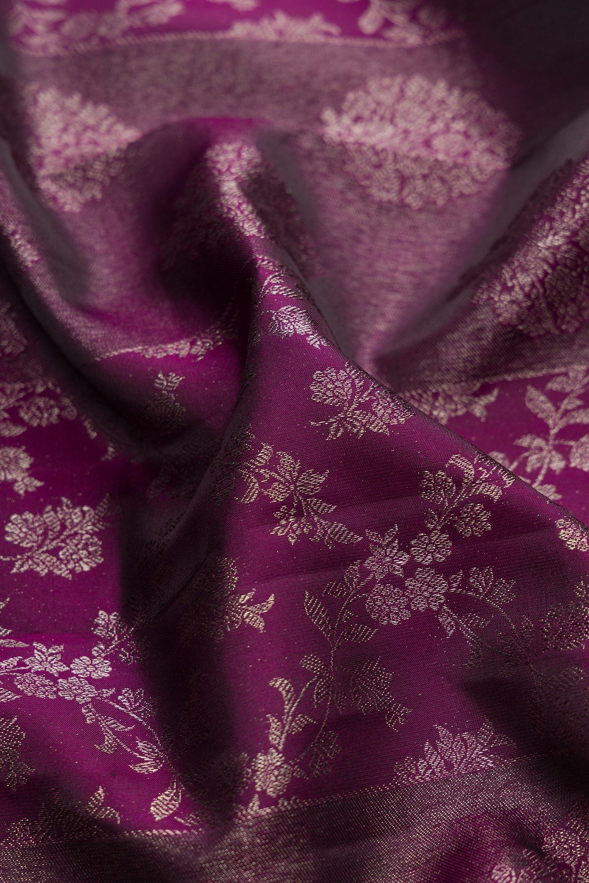 Close up of Burgundy Dual Tone Kanjivaram Silk Saree with Zari Brocade on the body and Zari Border.  displaying folds