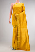 Yellow Kanchipuram Silk Saree with Zari Brocade on the body and Zari Border.  displayed on a mannequin