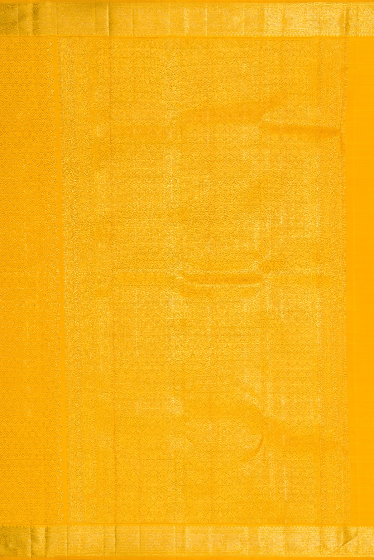 Close up image of the pallu of Yellow Kanchipuram Silk Saree with Zari Brocade on the body and Zari Border. 