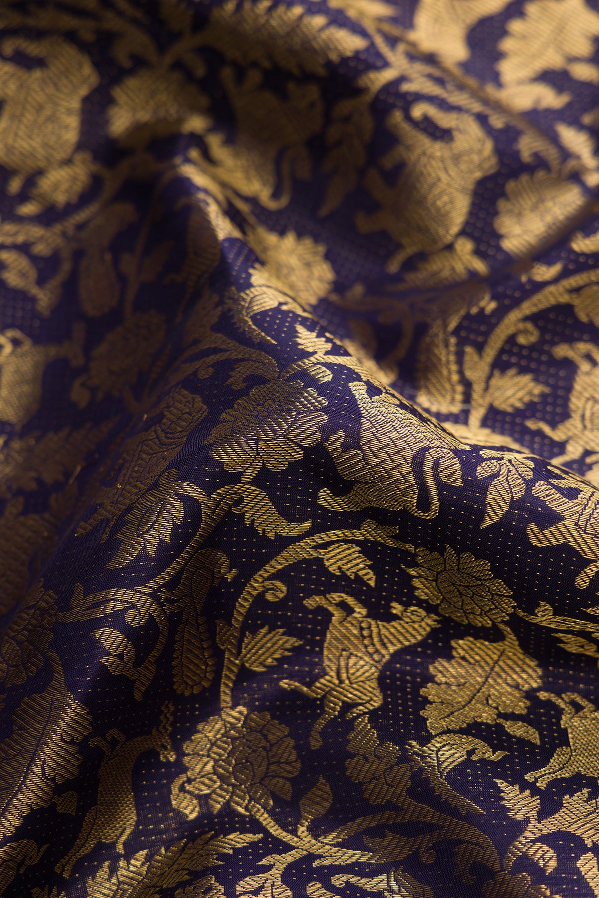 Close up of Navy Blue Kanchipuram Silk Saree with Zari Brocade on the body and Zari Border.  displaying folds