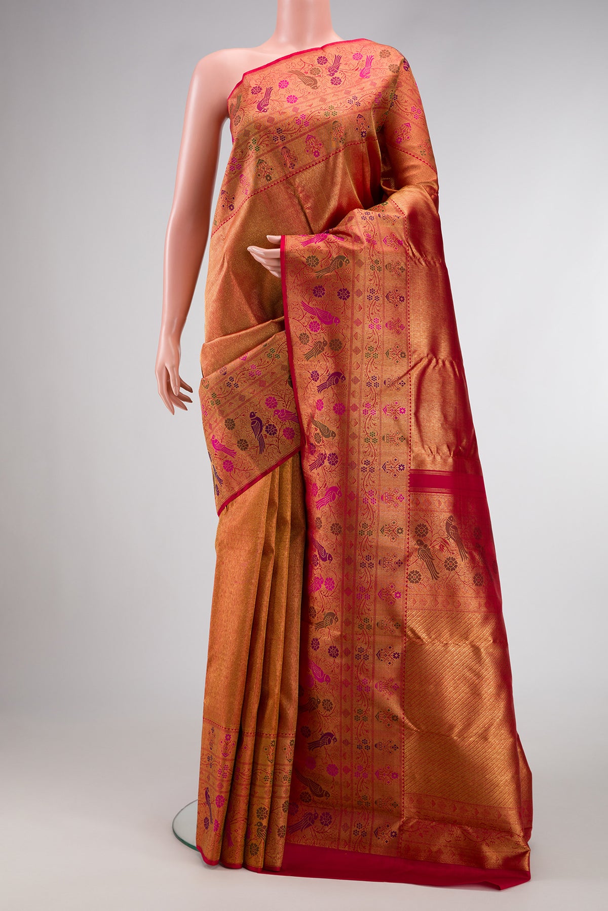 Gold with Red Color Kanjivaram Silk Saree with Zari Brocade on the body and Fancy Border.  displayed on a mannequin