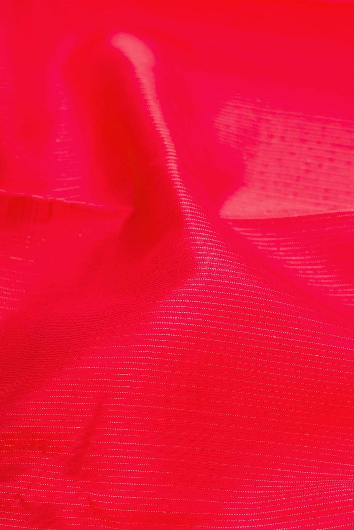 Close up of Red Dual Tone Kanjivaram Silk Saree with Stripes on the body and Without Border.  displaying folds