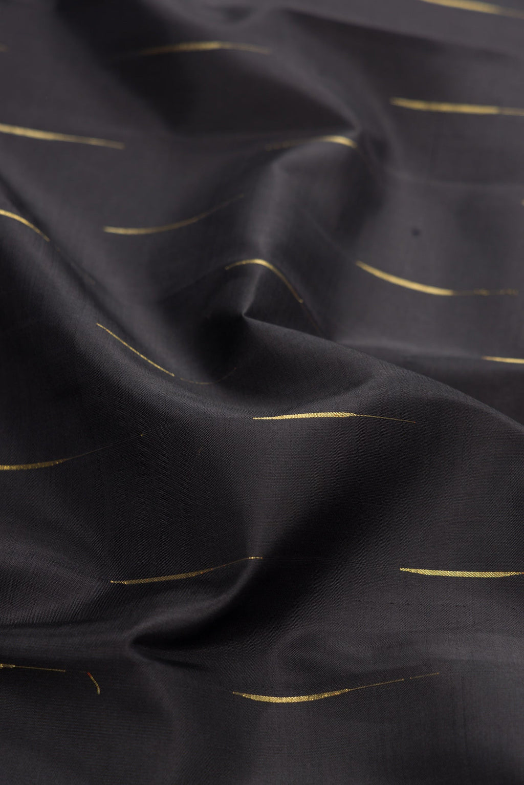 Close up of Black Dual Tone Kanjivaram Silk Saree with Zari Butta on the body and Zari Border.  displaying folds