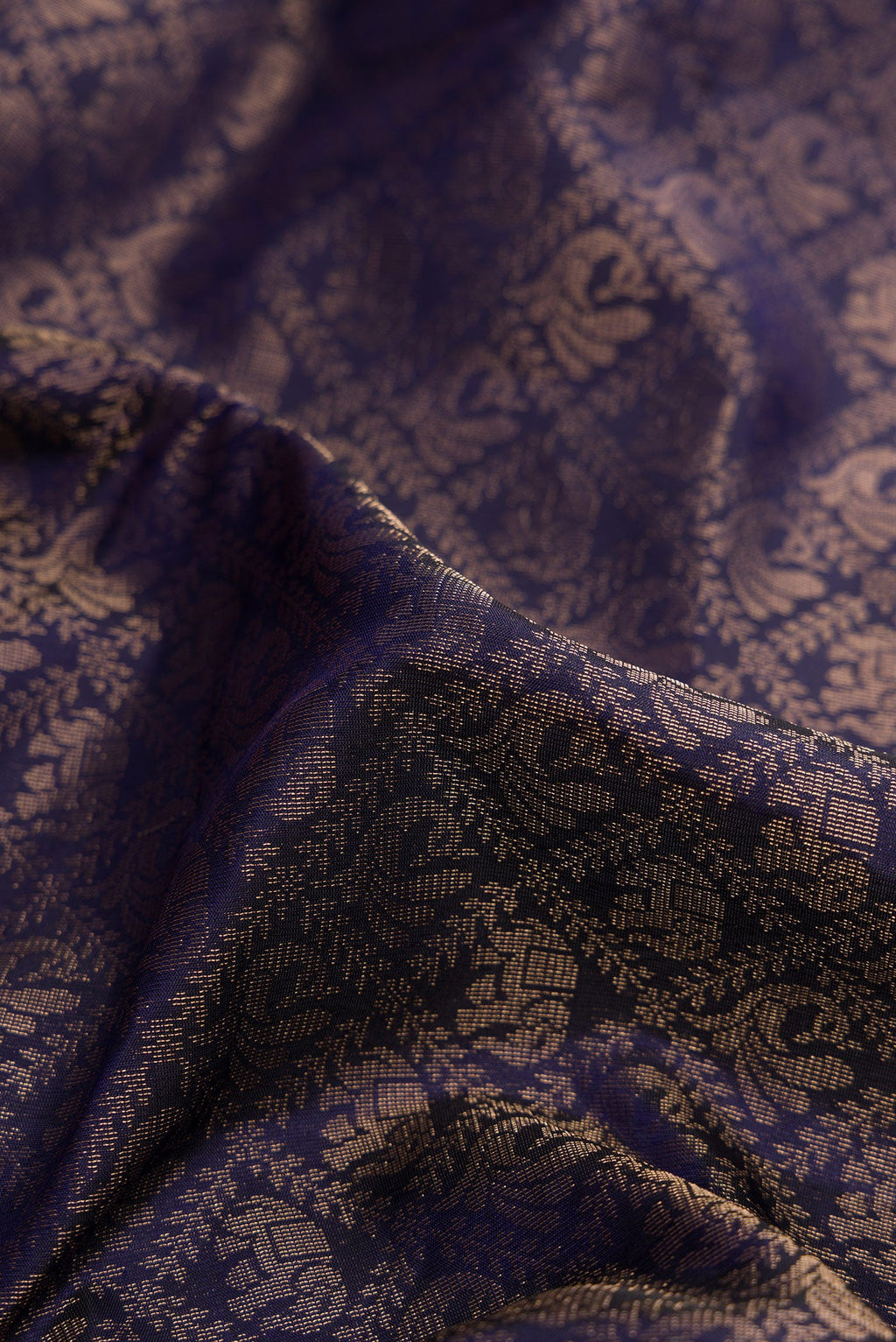 Close up of Navy Blue Dual Tone Soft Silk Saree with Zari Brocade on the body and Fancy Border.  displaying folds