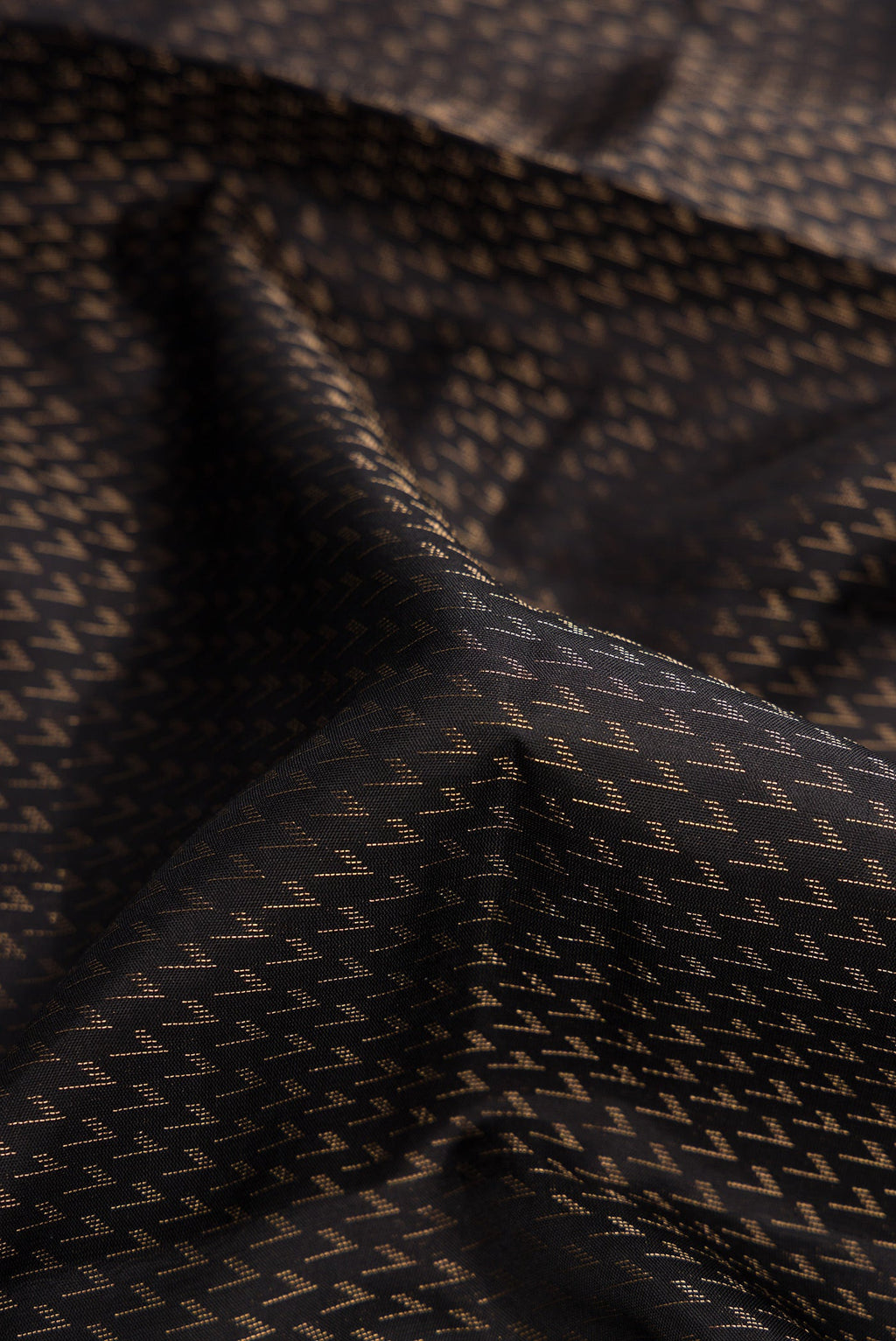 Close up of Black Dual Tone Soft Silk Saree with Zari Brocade on the body and Fancy Border.  displaying folds