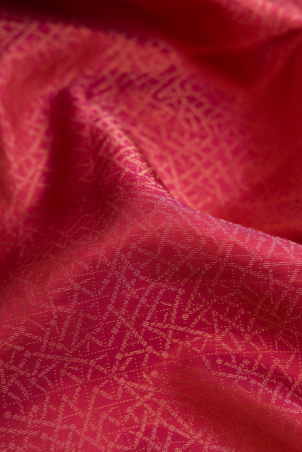 Close up of Brick Orange Dual Tone Soft Silk Saree with Zari Brocade on the body and Fancy Border.  displaying folds