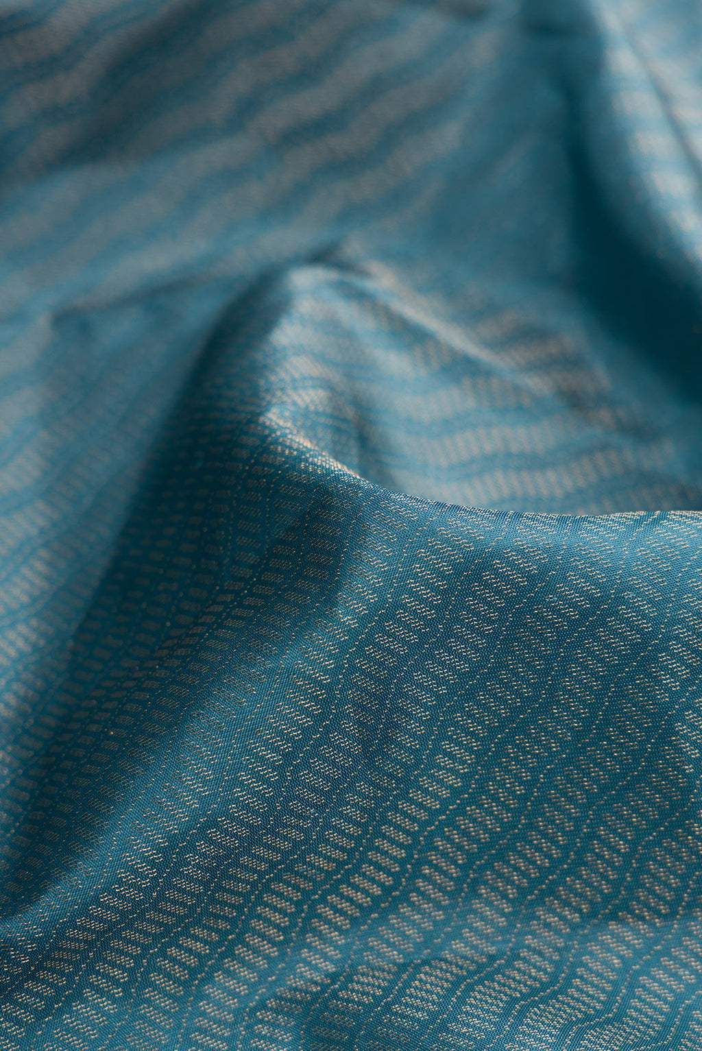 Close up of Maya Blue Dual Tone Soft Silk Saree with Zari Brocade on the body and Fancy Border.  displaying folds