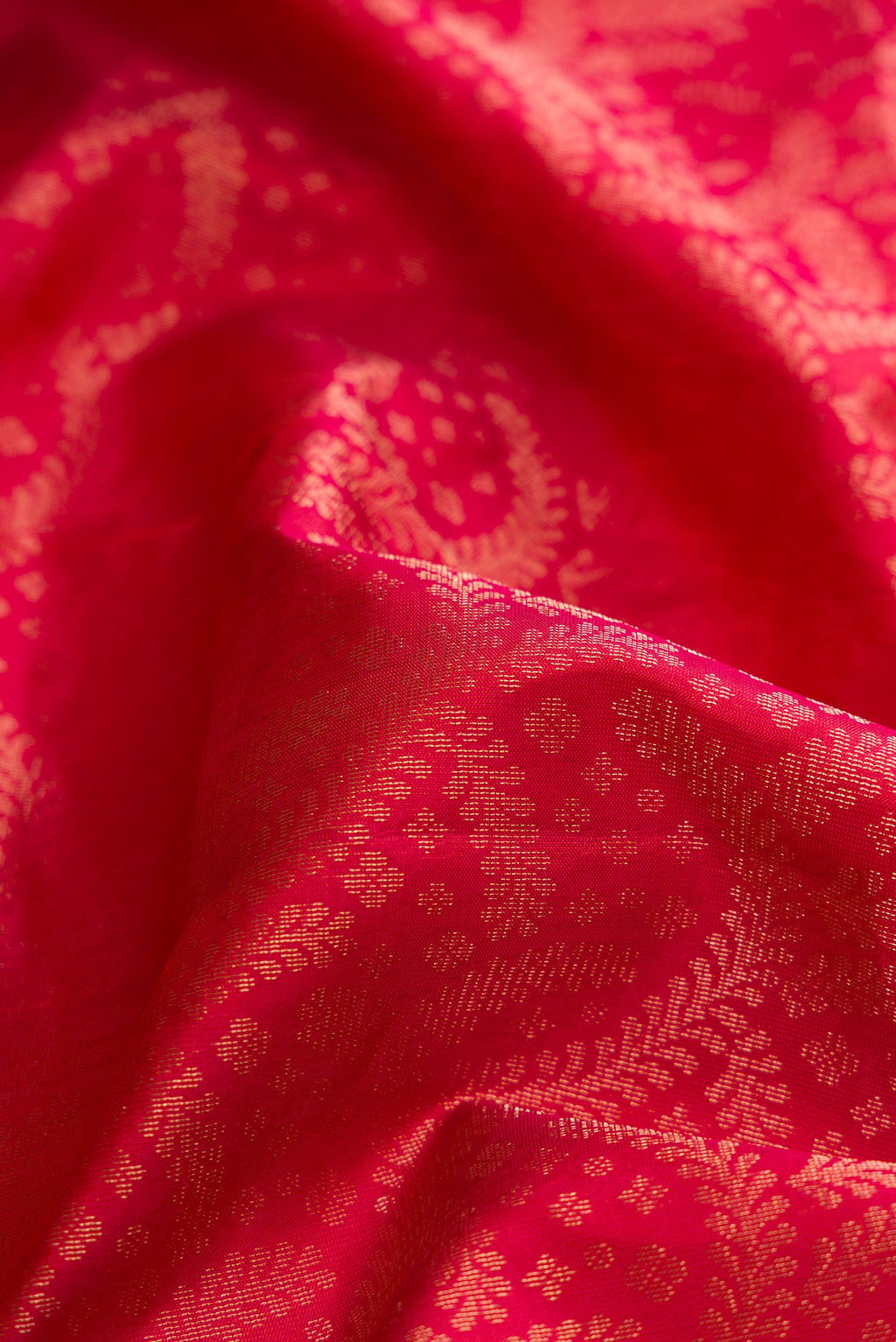 Close up of Brick Orange Dual Tone Soft Silk Saree with Zari Brocade on the body and Fancy Border.  displaying folds