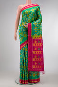 Green Dual Tone Soft Silk Saree with Ikat Print on the body and Zari Border.  displayed on a mannequin