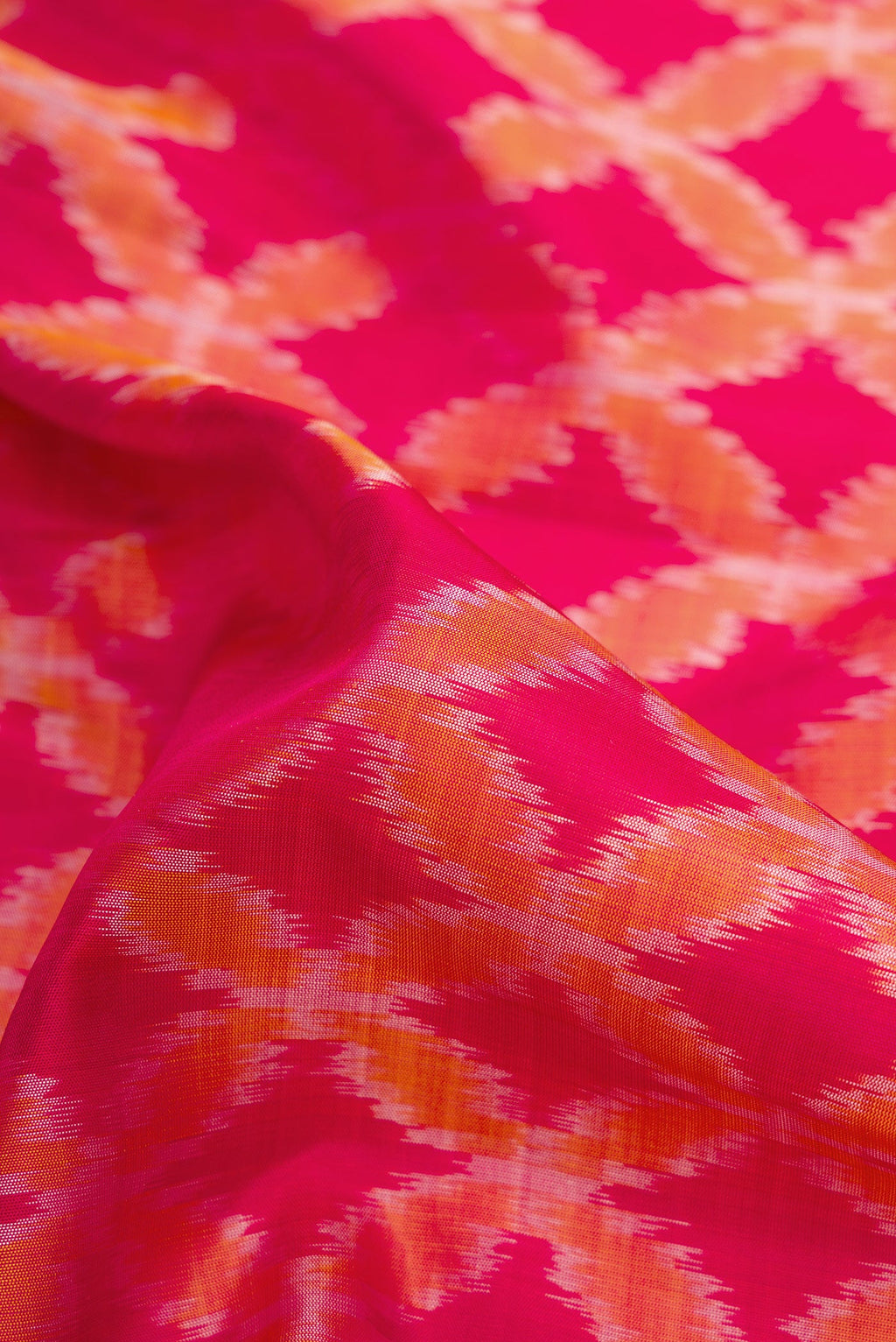 Close up of Dark Pink Dual Tone Soft Silk Saree with Ikat Print on the body and Zari Border.  displaying folds